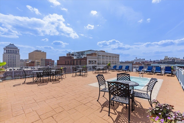 view of patio / terrace with a view of city and outdoor dining area