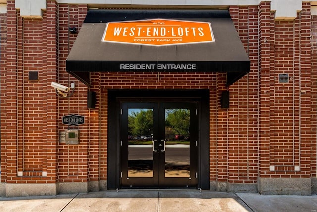 view of exterior entry with french doors and brick siding