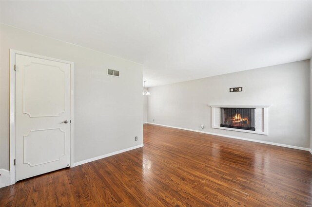 unfurnished living room featuring a fireplace and hardwood / wood-style flooring