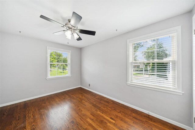 spare room featuring a healthy amount of sunlight, hardwood / wood-style flooring, and ceiling fan