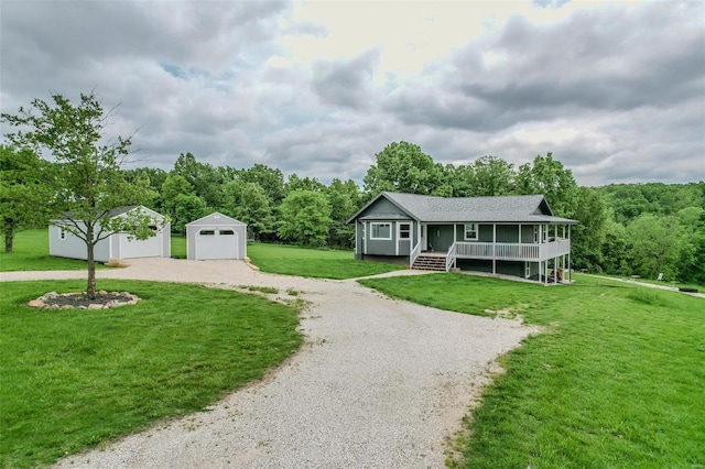 view of front facade featuring a garage, a front lawn, a porch, and an outdoor structure