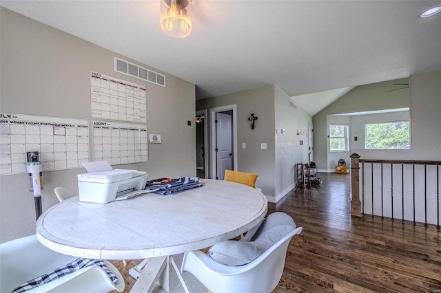 dining area with lofted ceiling and dark hardwood / wood-style floors