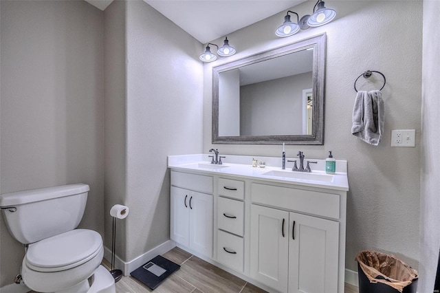 bathroom with vanity, toilet, and hardwood / wood-style flooring