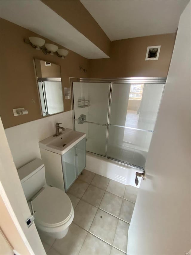 bathroom with vanity, toilet, and tile patterned flooring