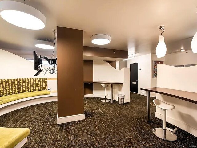 interior space featuring white cabinets and pendant lighting