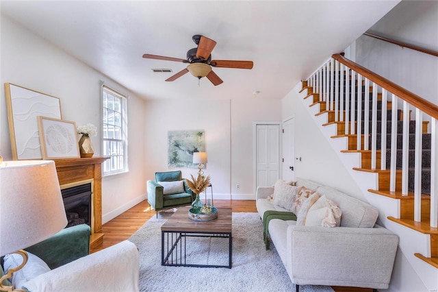 living room featuring ceiling fan and hardwood / wood-style floors