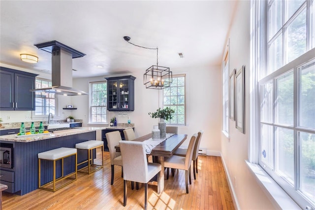 dining space with light hardwood / wood-style floors and a wealth of natural light