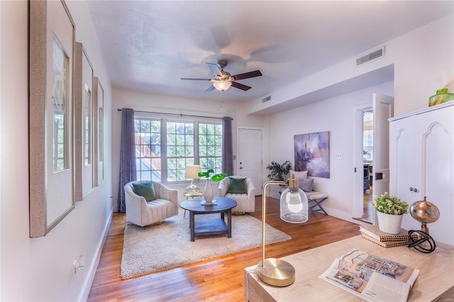 living room with hardwood / wood-style floors and ceiling fan