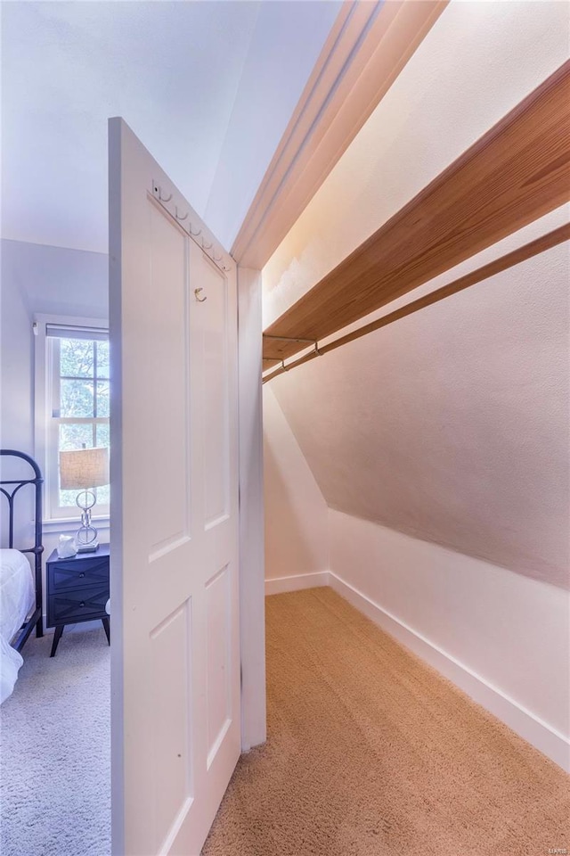 interior space with lofted ceiling and light colored carpet