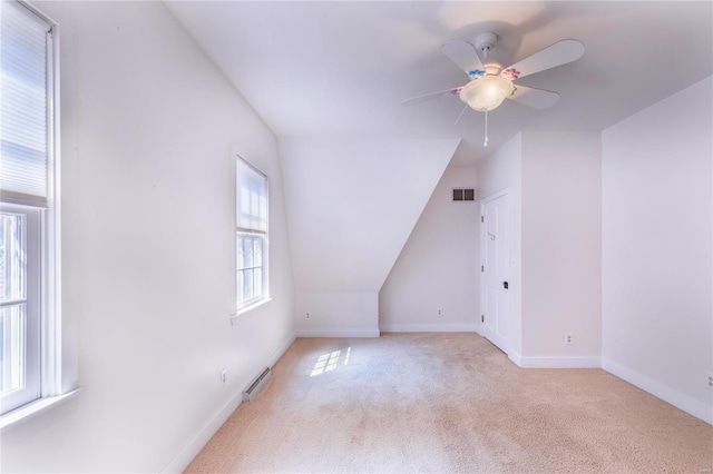 bonus room featuring light carpet, a baseboard radiator, ceiling fan, and vaulted ceiling