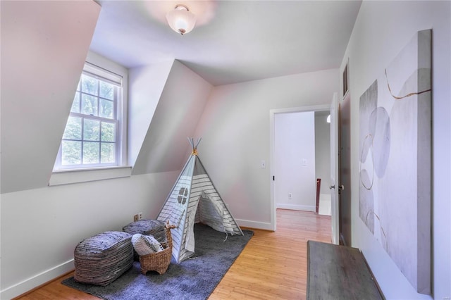 game room with light hardwood / wood-style flooring