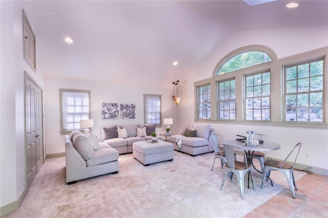 living room featuring light tile patterned floors and high vaulted ceiling