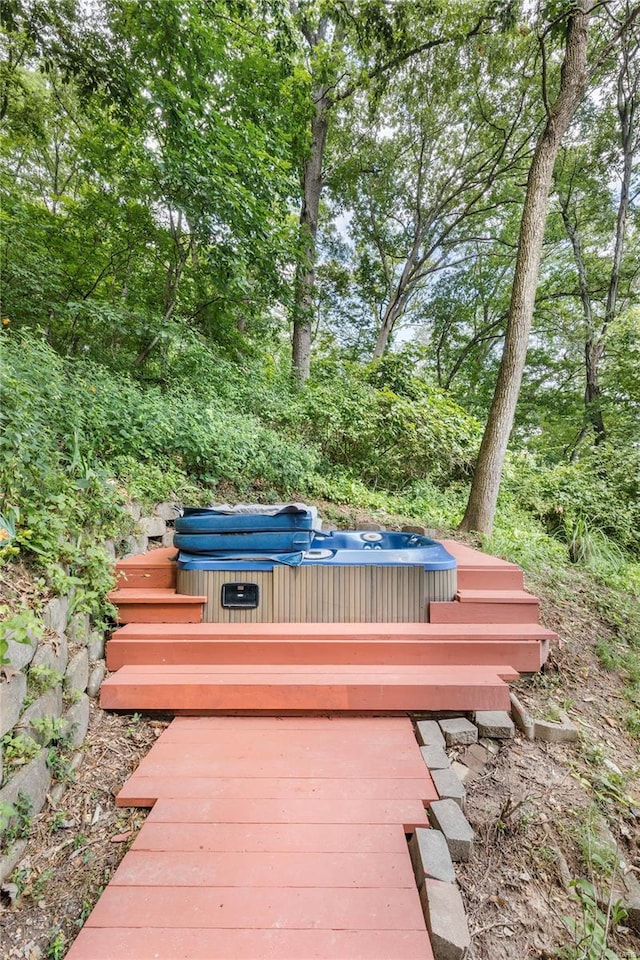 wooden deck with a hot tub