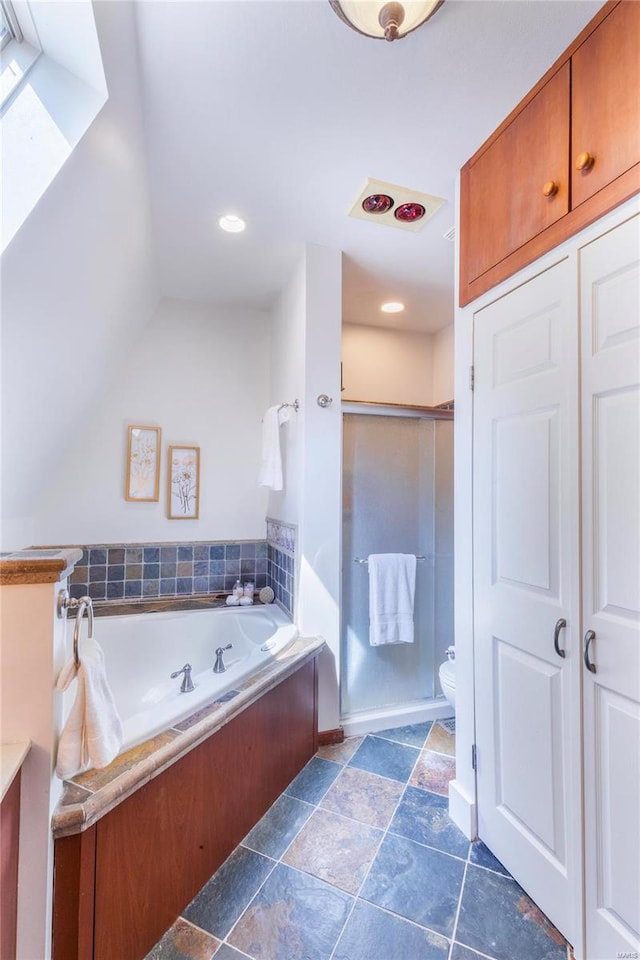 bathroom featuring toilet, tile patterned flooring, and a bath