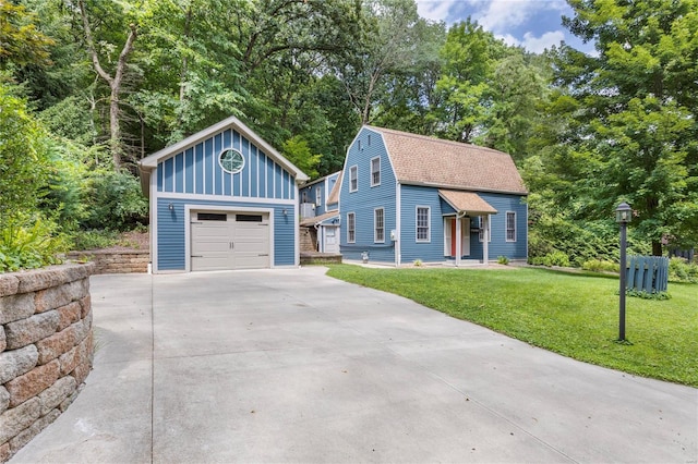 view of front of house with a garage and a front yard