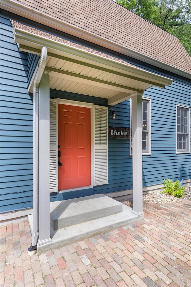 view of exterior entry with a porch