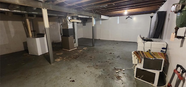 basement featuring heating unit and washer / dryer