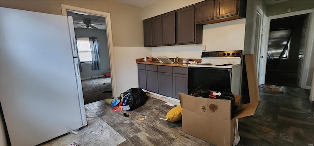 kitchen with dark brown cabinetry, white appliances, and ceiling fan