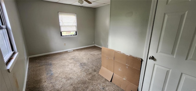 carpeted spare room with ceiling fan