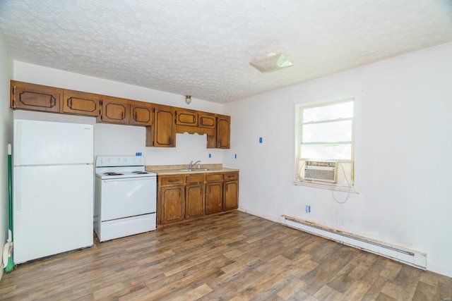 kitchen with cooling unit, sink, white appliances, a baseboard heating unit, and dark hardwood / wood-style floors