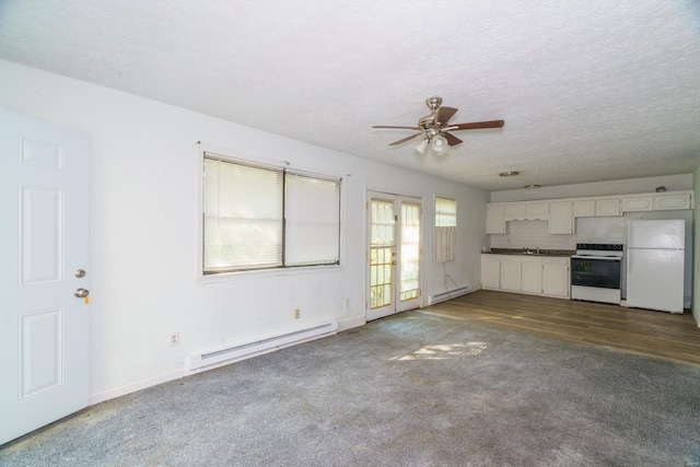 unfurnished living room with a baseboard heating unit, ceiling fan, wood-type flooring, and a textured ceiling