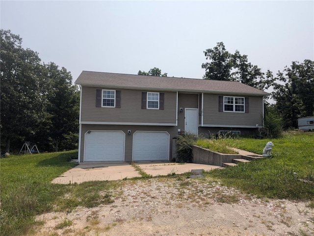 split foyer home with a garage and a front lawn