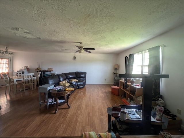 living room with hardwood / wood-style flooring, a textured ceiling, a wealth of natural light, and ceiling fan