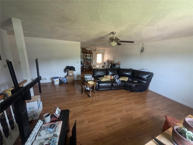 living room featuring a textured ceiling, ceiling fan, and hardwood / wood-style floors