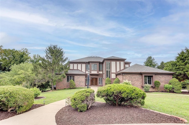 english style home featuring a front lawn