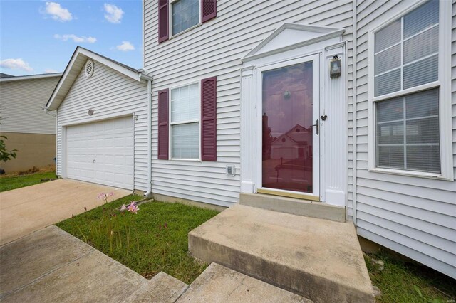 view of exterior entry with a garage