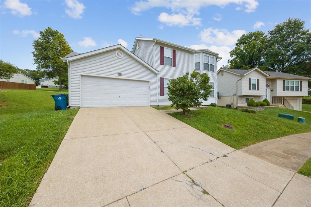 view of front of property featuring a garage and a front yard