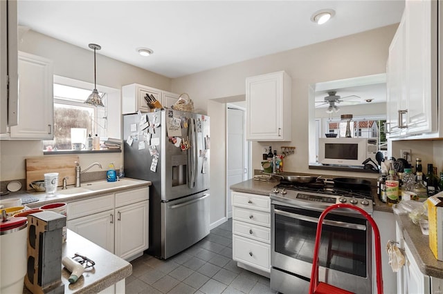 kitchen with white cabinets, appliances with stainless steel finishes, a wealth of natural light, and ceiling fan