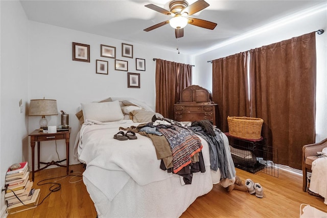 bedroom with hardwood / wood-style floors and ceiling fan