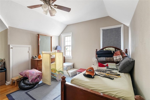 bedroom featuring light hardwood / wood-style floors, ceiling fan, and lofted ceiling