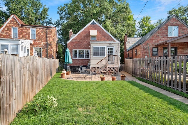 back of house with a patio area and a yard