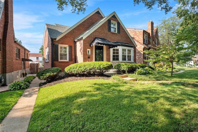 tudor house featuring a front yard