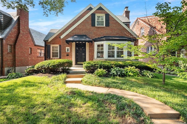 tudor home with a front lawn