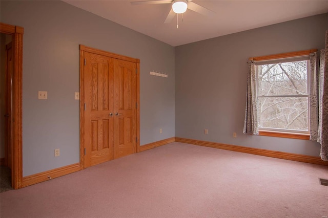 unfurnished bedroom featuring ceiling fan and light carpet