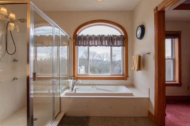 bathroom featuring tile patterned floors and separate shower and tub