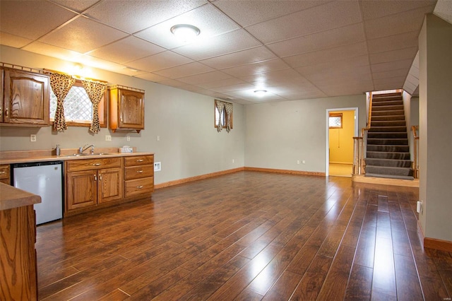 kitchen with dishwasher, a drop ceiling, dark hardwood / wood-style flooring, and sink