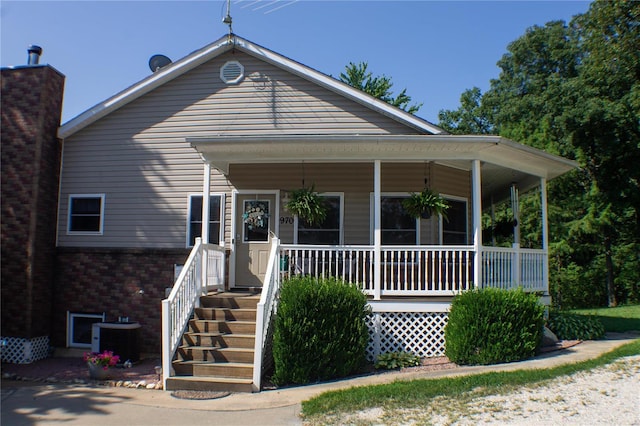 view of front facade with a porch and cooling unit