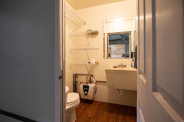 bathroom featuring hardwood / wood-style floors and toilet