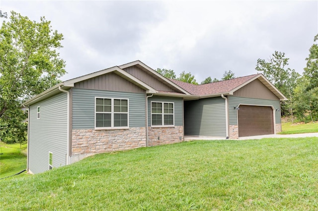 view of front of property with a garage and a front lawn