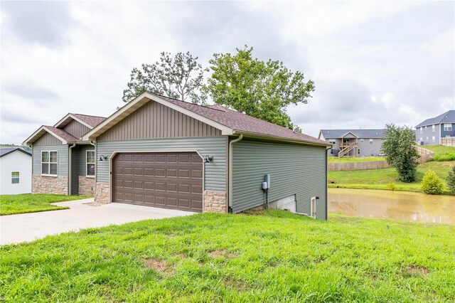 exterior space featuring a lawn, concrete driveway, and a garage