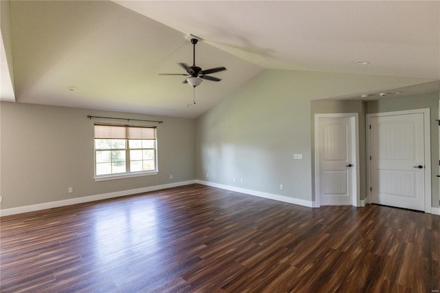 spare room featuring dark wood-type flooring, a ceiling fan, and vaulted ceiling