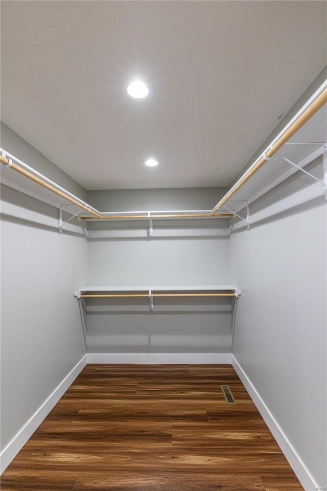 walk in closet with wood finished floors and visible vents