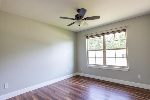 unfurnished room featuring ceiling fan, baseboards, visible vents, and dark wood-style floors