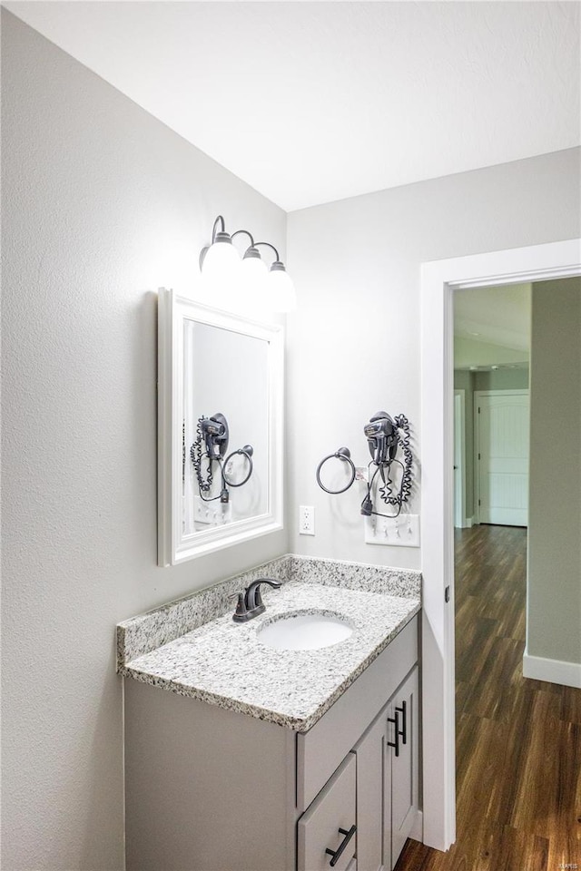 bathroom with vanity and hardwood / wood-style floors