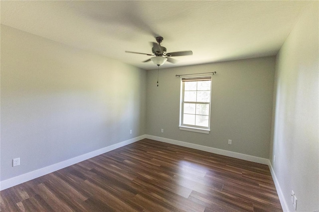 unfurnished room featuring baseboards, dark wood-style floors, and ceiling fan