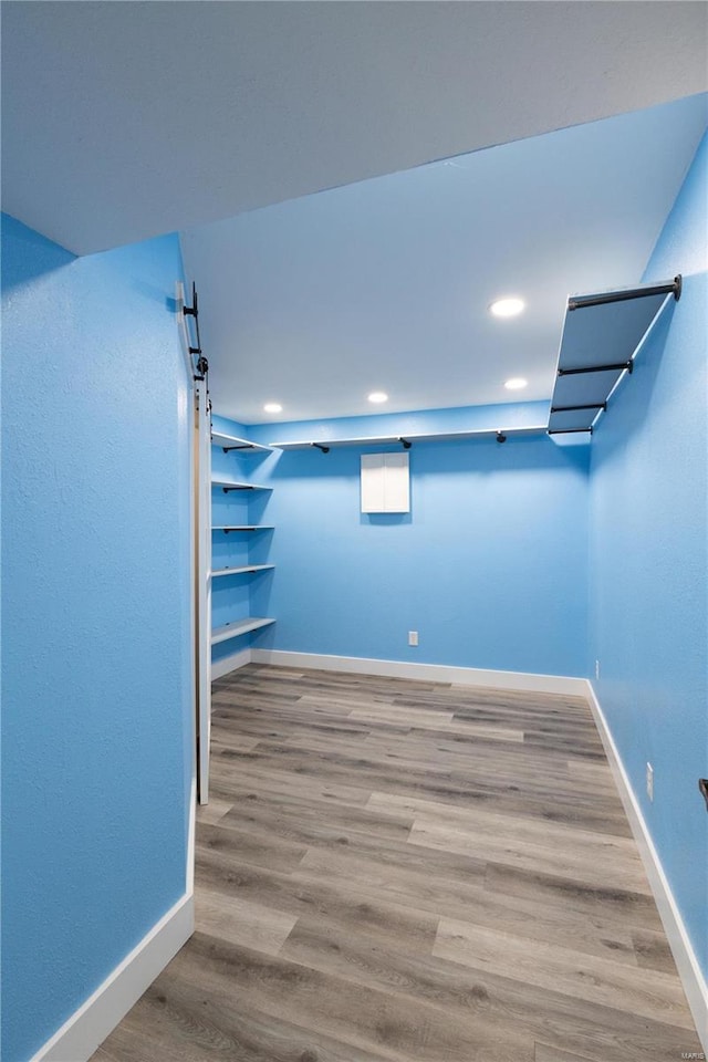 basement with light hardwood / wood-style flooring